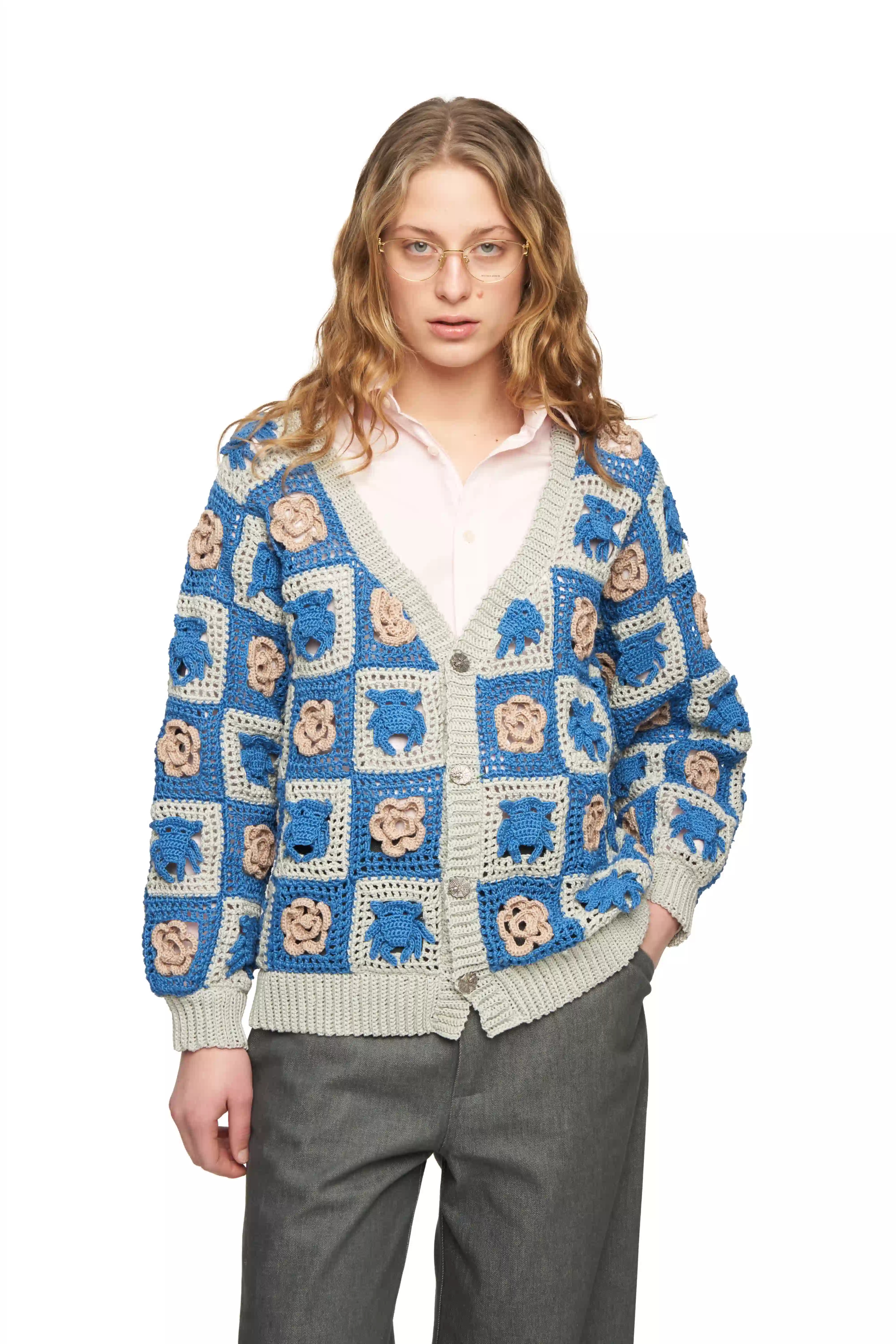 Кардиган связан крючком из хлопка в технике бабушкин квадрат. Модель собрана из отдельных квадратов с рельефными мотивами — фирменные Чихпауки и розы чередуются, формируя узнаваемый графический орнамент.

Свободный унисекс-силуэт, V-образный вырез и застёжка на декоративные пуговицы в виде паутины делают модель удобной и выразительной.

Серо-синяя цветовая гамма в сочетании с бежевыми элементами подчёркивает фактуру ручной вязки и делает мотивы Чихпауков особенно выразительными — графично, спокойно и современно.